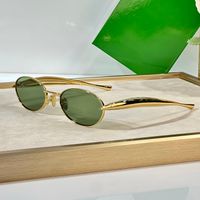 Gold frame green lens