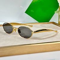 Gold frame light grey lens