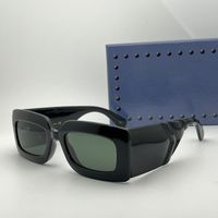 Black frame green lens